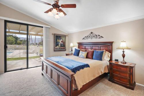 a bedroom with a bed and a ceiling fan at 2BR 2BA Charming Cathedral City Condo with Territorial Views in Cathedral City
