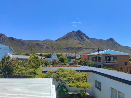 a view of a city with mountains in the background at Scenic Bliss Holiday Home in Kleinmond