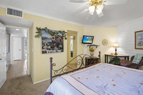 a bedroom with a bed and a living room at 2BR 2BA Charming Cathedral City Condo with Territorial Views in Cathedral City