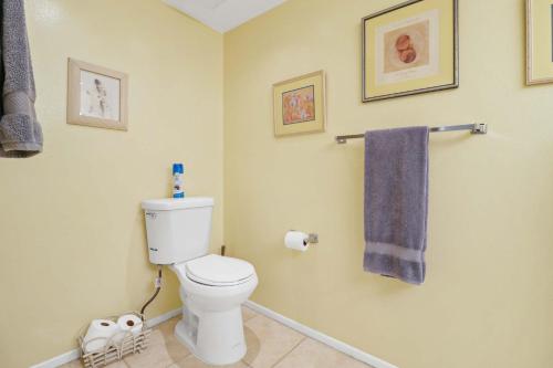 a bathroom with a toilet and a blue towel at 2BR 2BA Charming Cathedral City Condo with Territorial Views in Cathedral City
