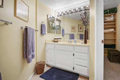 a bathroom with a sink and a mirror at 2BR 2BA Charming Cathedral City Condo with Territorial Views in Cathedral City