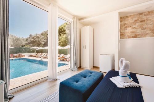 a living room with a blue couch and a swimming pool at Eman Resort & Villas in Ulcinj