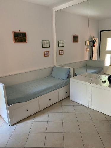 a room with a bed and a sink and a mirror at Rondinella in San Vito Chietino