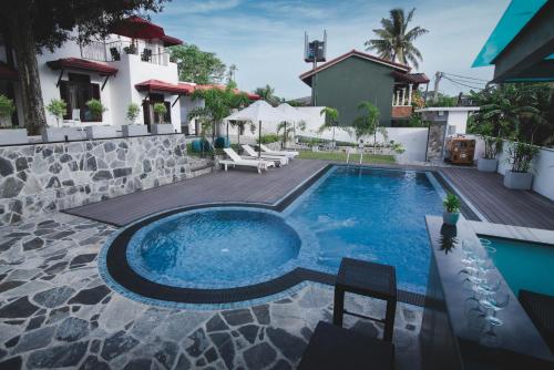 a swimming pool in the backyard of a house at Travel Cage in Hikkaduwa