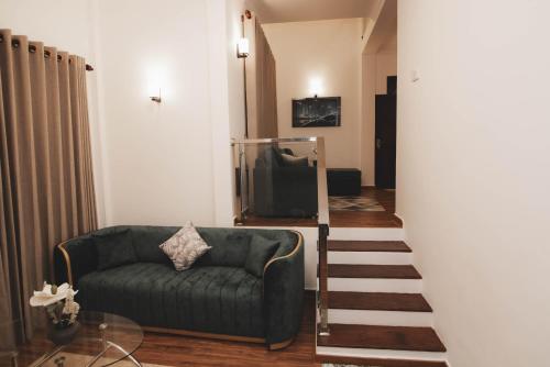 a living room with a couch and a television at Travel Cage in Hikkaduwa