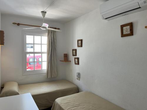 a room with two beds and a window at ES CASTELL 1 6 by SOM Menorca in Fornells