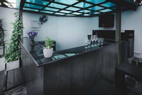 a bar in a restaurant with glasses on the counter at Travel Cage in Hikkaduwa