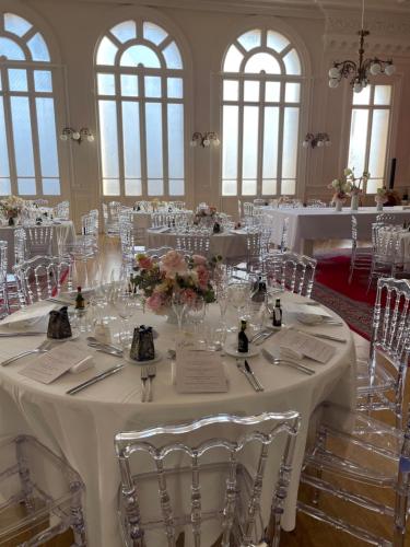 a banquet hall with white tables and chairs at Salon Boyer in Épernay