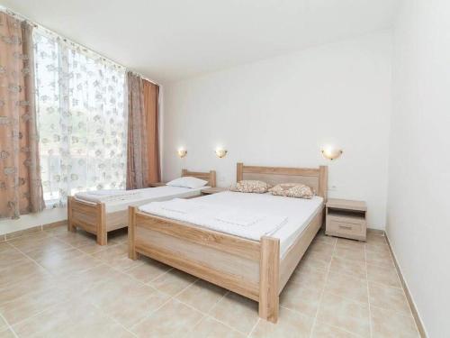 a bedroom with two beds and a window at Villa INA in Kaluđerac