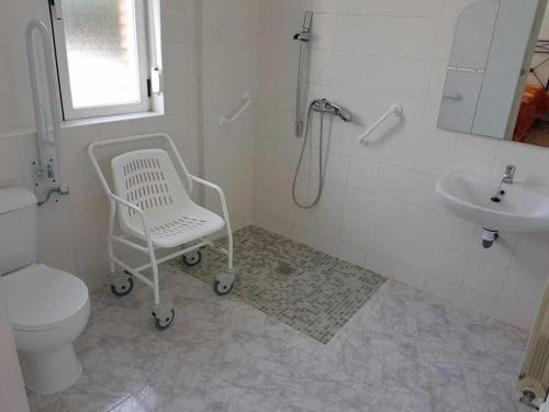 a bathroom with a white toilet and a sink at Albergue Ciudad del Doncel in Sigüenza
