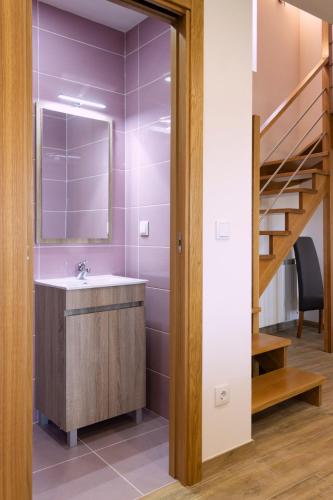 a bathroom with a sink and a staircase at Casa da Ladeira in Videmonte
