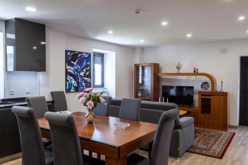 a living room with a dining room table and chairs at Casa da Ladeira in Videmonte