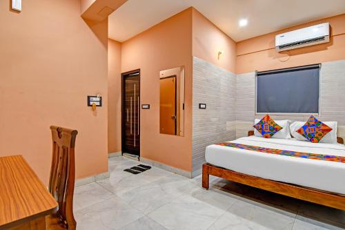 a bedroom with a large bed in a room at FabHotel The Ax Inn in Kolkata