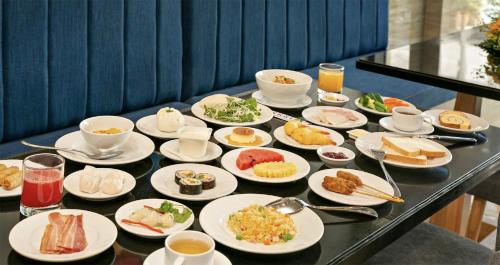 a table with plates of food on a table at Blue Ocean View Stay in Da Nang