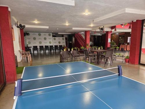 a blue ping pong table in the middle of a room at Girivihar Holiday Club - Pure Veg in Lonavala