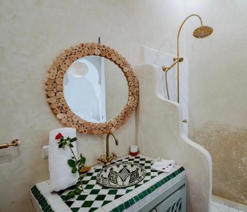 a bathroom with a mirror and a sink at Dar Inara in Marrakech
