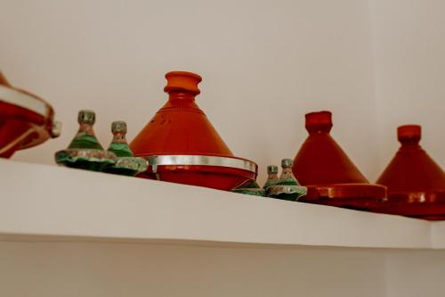 a group of bottles sitting on top of a shelf at Dar Inara in Marrakech