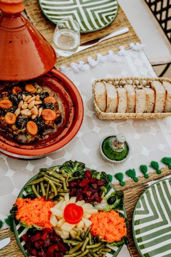 a table with plates of food on a table at Dar Inara in Marrakech