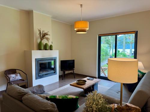 a living room with a couch and a fireplace at Lakeview Green Paradise in Sete Cidades