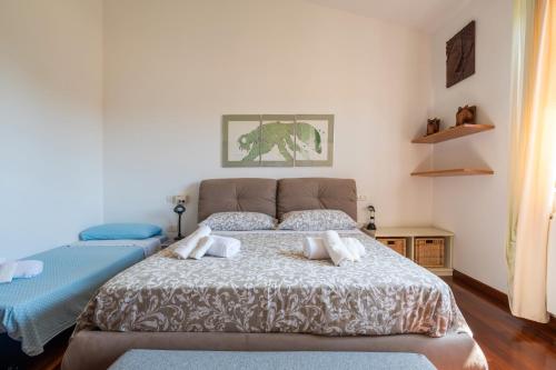 a bedroom with a bed with two pillows on it at Villa Pilato in Poggio Dei Pini