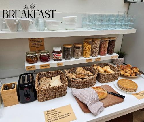 a bakery counter with bread and baskets of food at Hotel Claris in Prague