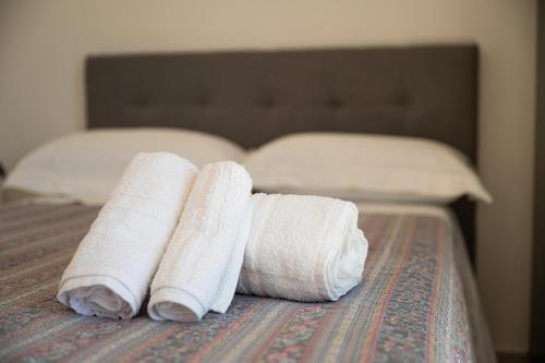 two rolled towels sitting on top of a bed at Villa Pilato in Poggio Dei Pini