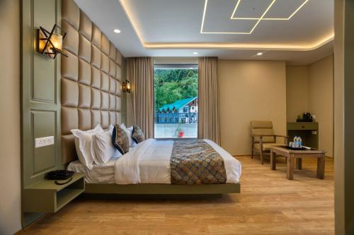 a bedroom with a large bed and a window at Mountain Nest A Boutique Stay Near Dal Lake, Srinagar in Srinagar