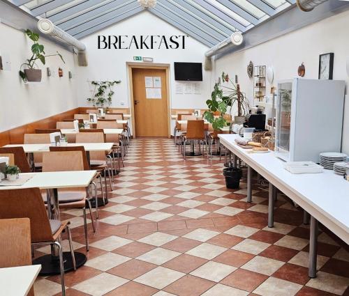 a restaurant with tables and chairs in a room at Hotel Claris in Prague