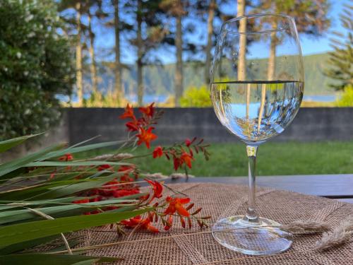 a wine glass sitting on top of a table at Lakeview Green Paradise in Sete Cidades