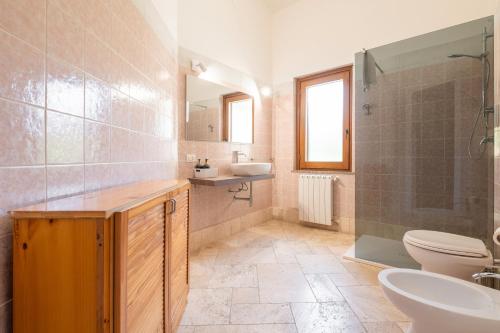 a bathroom with a sink and a toilet and a shower at Villa Pilato in Poggio Dei Pini