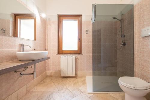 a bathroom with a sink and a toilet and a shower at Villa Pilato in Poggio Dei Pini