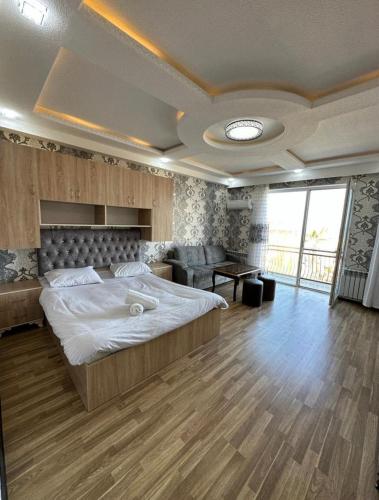 a large bedroom with a large bed and a couch at Astara Boulevard 1 -4 in Astara
