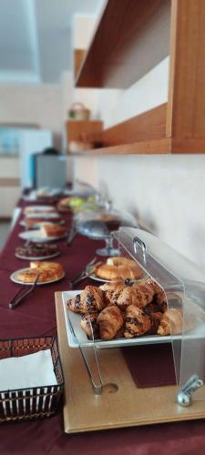 a buffet with pastries and pastries on a table at Hotel Acerboli in Rimini