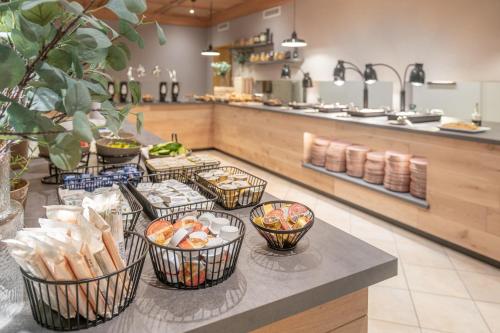 a buffet line with bowls of food on a table at Alpenhotel Tirolerhof Gerlos in Gerlos