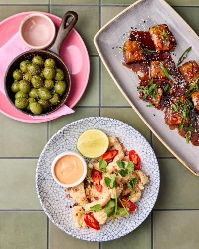 a table with two plates of food and a pan of food at The Lucky Hotel in Newcastle