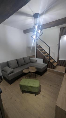 a living room with a couch and a table at Central House Niš in Niš