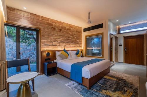 a bedroom with a large bed and a table at Mahavan Resort in Chitrod