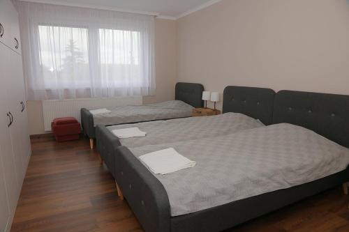 Ένα ή περισσότερα κρεβάτια σε δωμάτιο στο Szemerey Pince Apartman