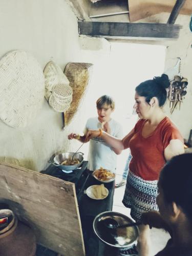 a man and a woman preparing food in a kitchen at Dearly Holiday Home And Safari in Tissamaharama