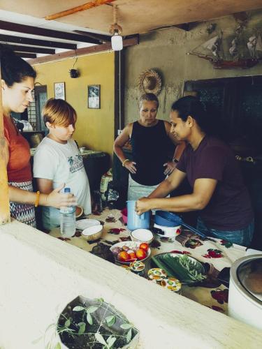 a group of people standing around a table preparing food at Dearly Holiday Home And Safari in Tissamaharama