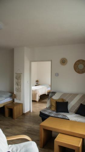 a living room with two beds and a couch at Apartmán Lnáře in Lnáře