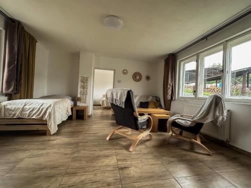 a bedroom with a bed and a desk and chairs at Apartmán Lnáře in Lnáře