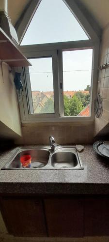 a kitchen sink with a window above it at Avec piscine 06-17-61-38-73 in Ifrane