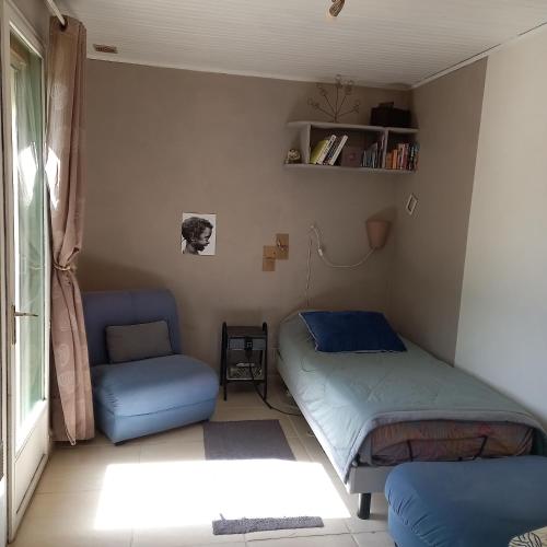 a room with a bed and a chair in it at Malpas125 chambres in Accons