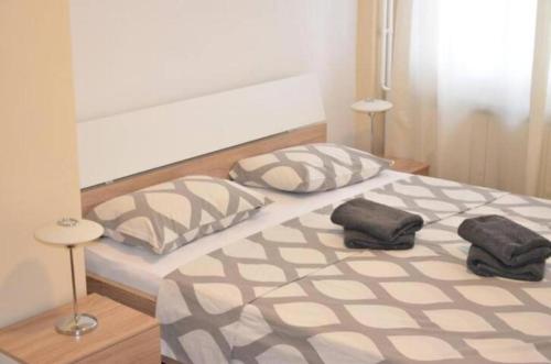 a bedroom with two pillows on a large bed at Apartments Sat in Belgrade