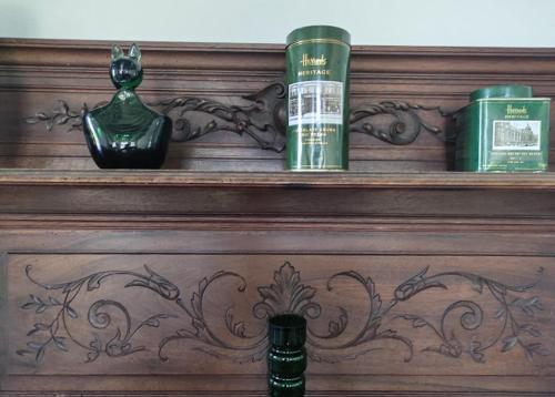 a wooden shelf with three bottles on top of it at Le Pavillon du château de Jean 