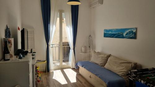 a living room with a couch and a window at Casa Isabel in Mazara del Vallo