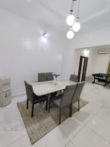 a dining room with a table and chairs at Keev Homes Comfy 4bedroom duplex in Port Harcourt