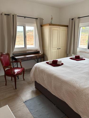 a bedroom with a bed and a desk and a chair at Quinta Madrugada Burgau in Luz