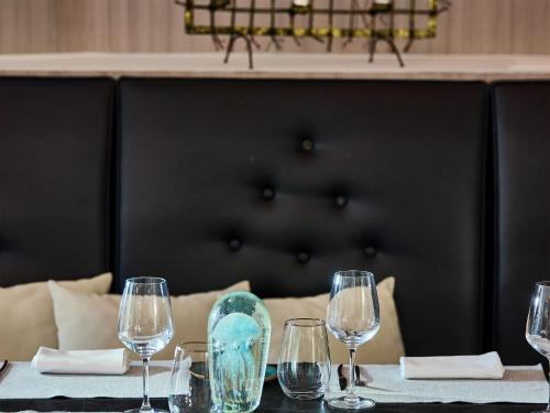 a table with wine glasses on top of it at Grecotel Creta Palace in Rethymno Town